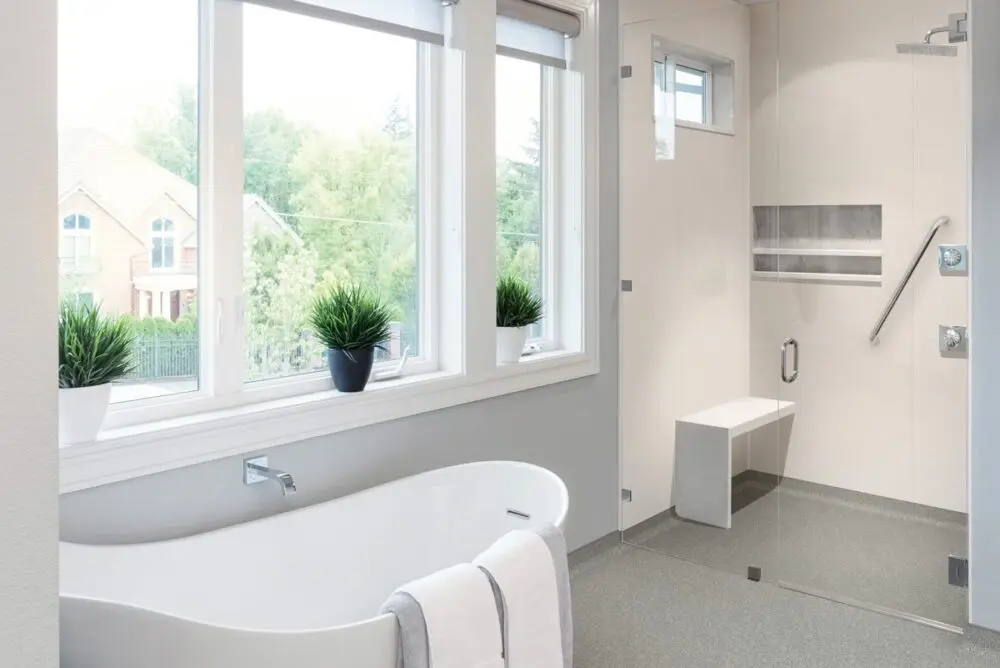 Corner Bath In Front Of Window With Large Walk In Shower