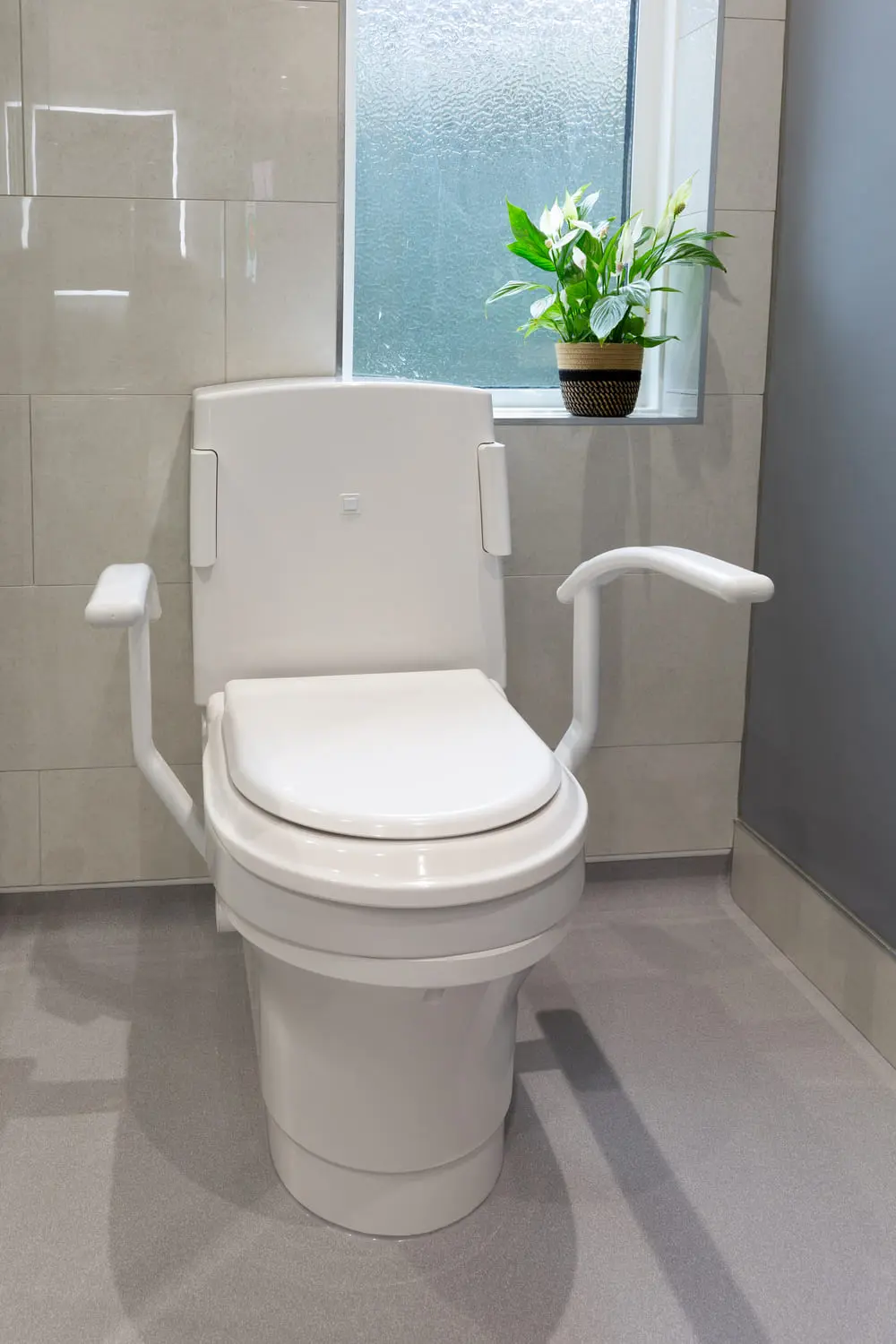 Bathroom with closomat toilet with plant