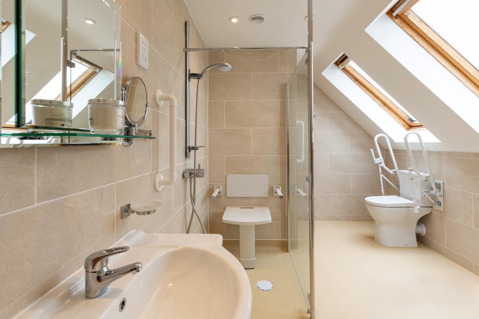 Large completed accessible bathroom in the eves of a house with level access shower area and comfort height WC