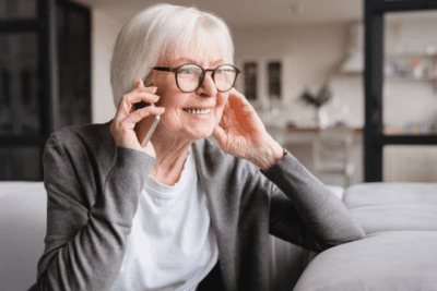 Elderly lady on the phone smiling