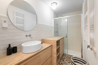 Cozy Bathroom With A Mirror Sink And Cabinets On The Backdrop Of