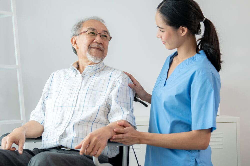 Happy Positive Asian Nurse Giving Support And Touching Contented