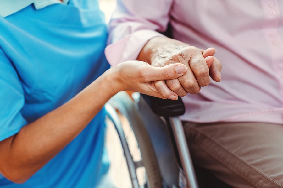 Bigstock Nurse Consoling A Senior Woman 323943850