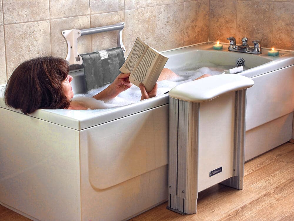 Lady reading book sitting in bath with Molly Bather