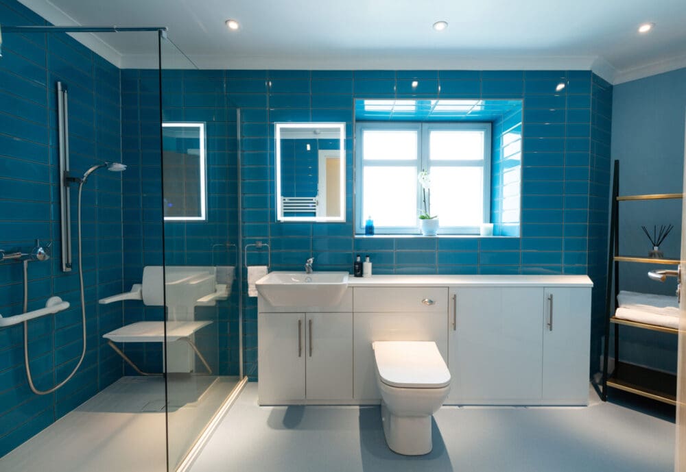 New accessible bathroom with level access shower incorporating a folding shower chair