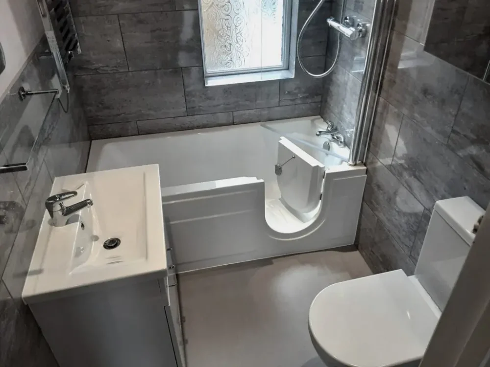 Mr And Mrs C's Bathroom After Renovation A Full Length Walk In Bath With Overhead Shower, New Modern Tiling And Fresh Accessible Design