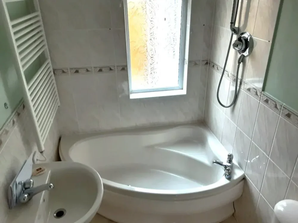 Mr And Mrs C's Bathroom Before Renovation A Curved Corner Bath Tub With No Easy Access, Overhead Shower And Sink All In A Dated Design