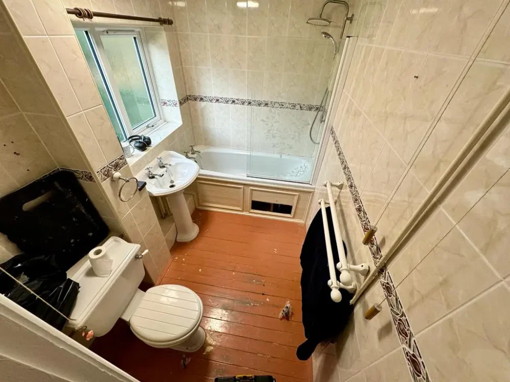 Mr And Mrs H's Bathroom Before Renovation A Standard Full Length Bath With No Accessible Entry Option, Overhead Shower, Wooden Flooring And Toilet