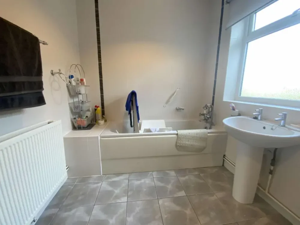 Mr And Mrs H's Bathroom Before Renovation Full Length Bath With No Access For Mobility Issues, With Sink, Large Window And Toiletries Storage