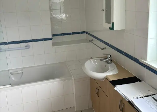 Mrs W's Bathroom Before Renovation A Full Length Bath With No Walk In Option, Pine Wood Colour Sink Cabinet And Small Sink