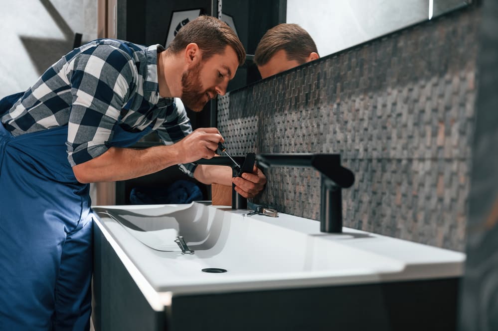 Plumber Fitting A Bathroom Sink